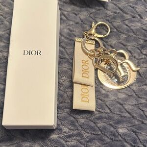 GWP Gold Tone Dior bag charm with cream Dior ribbon